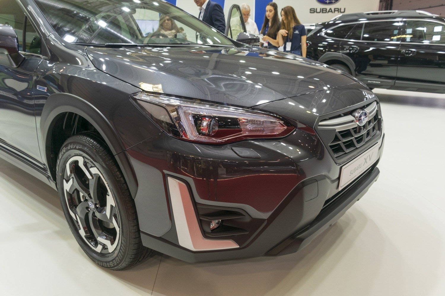 Close-up of front end focusing on headlights and wheel design.