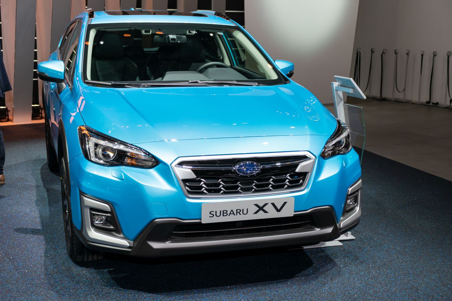 Front grille and headlights of a blue compact crossover SUV