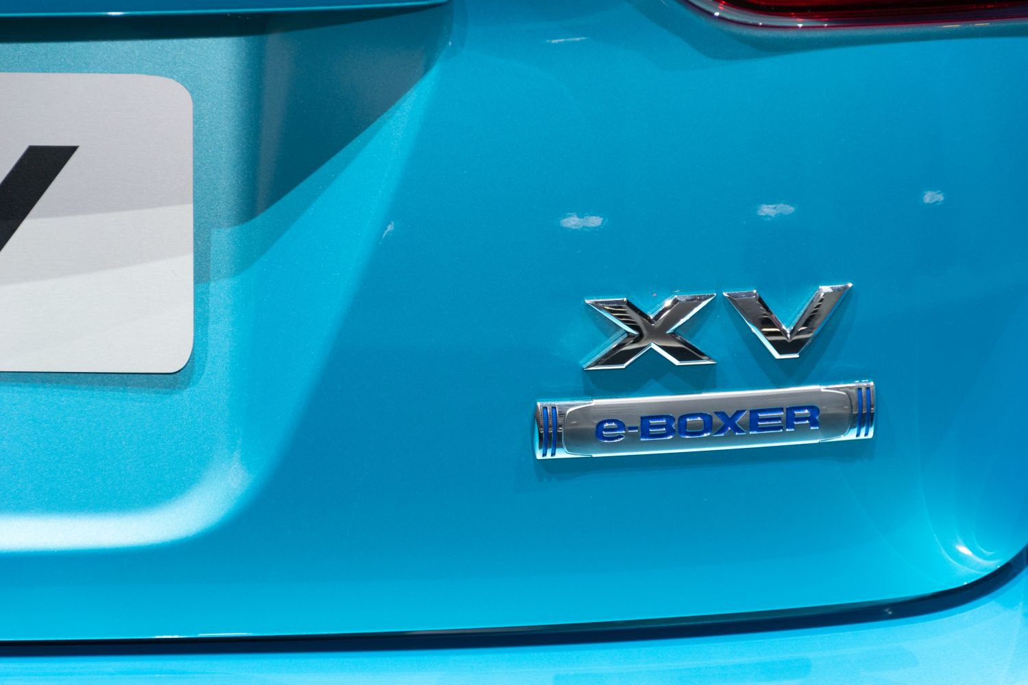 Close-up of Subaru XV and e-BOXER rear badges on blue paint