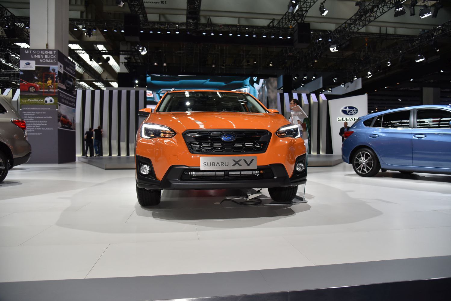 Bright orange SUV front with distinct grille and LED headlights