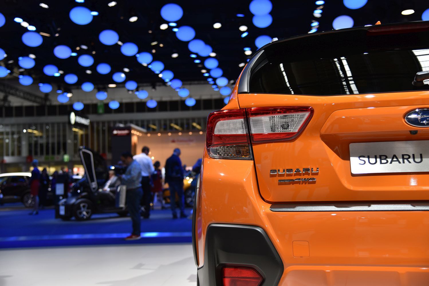 Rear section featuring tail light and AWD badge on vibrant orange body