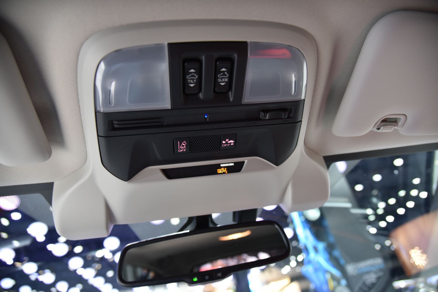 Interior roof console with tilt and slide controls, overhead lights, and rearview mirror