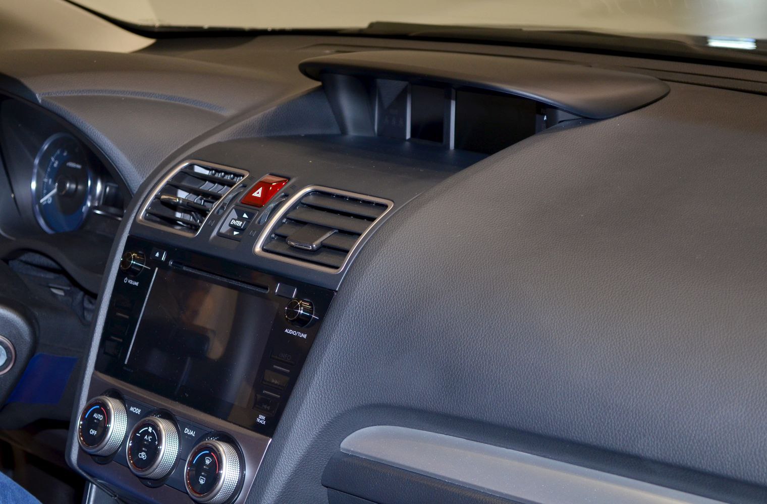 Dashboard with air vents, hazard button, and climate control knobs