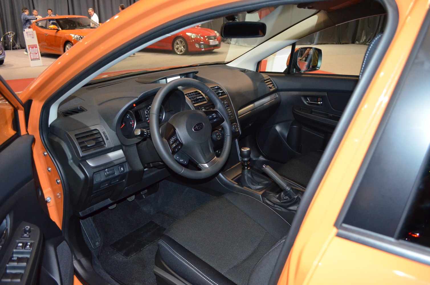 Modern car interior with dashboard, steering wheel, and manual gear lever