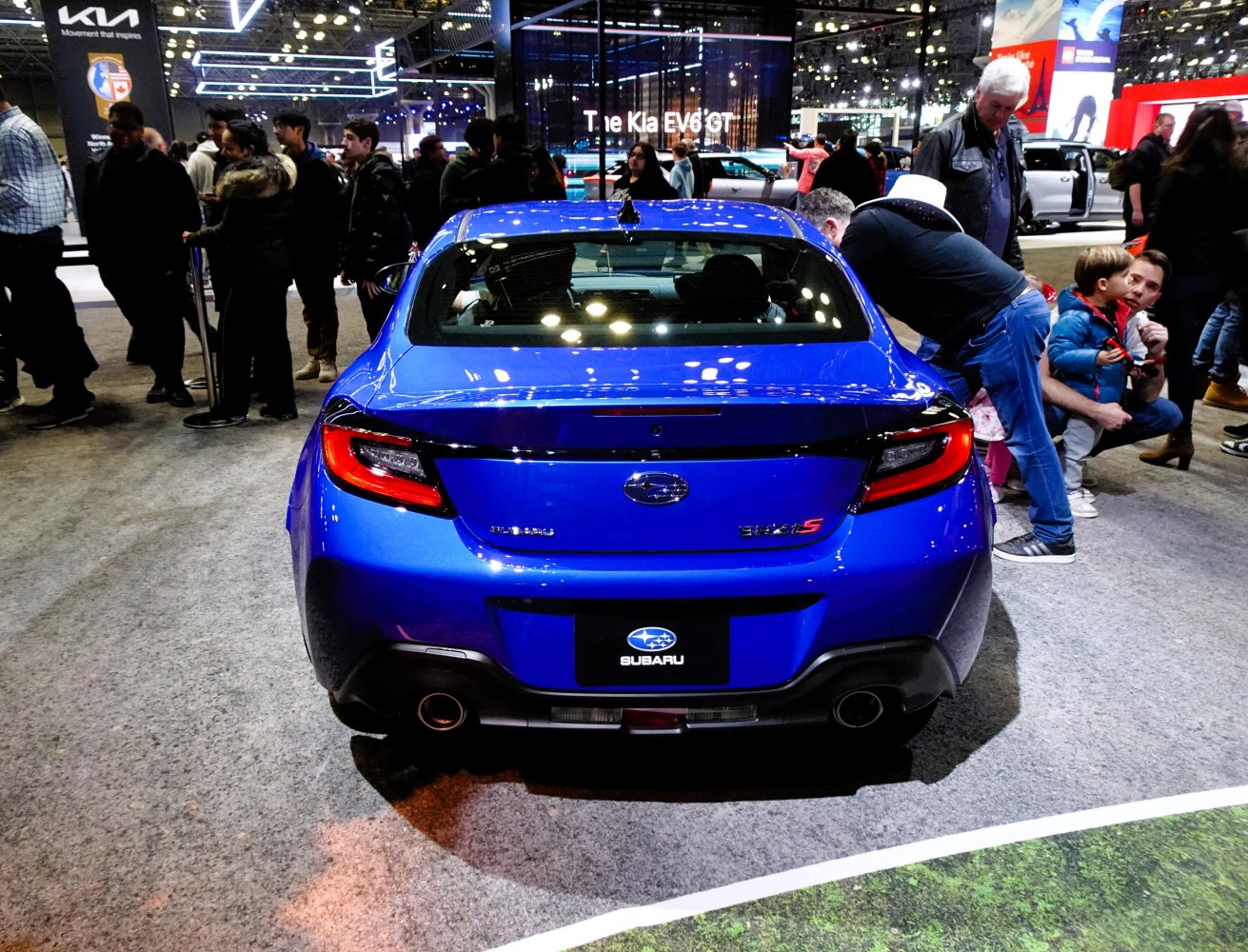 Rear view of blue sports coupe with dual exhaust and sporty taillights