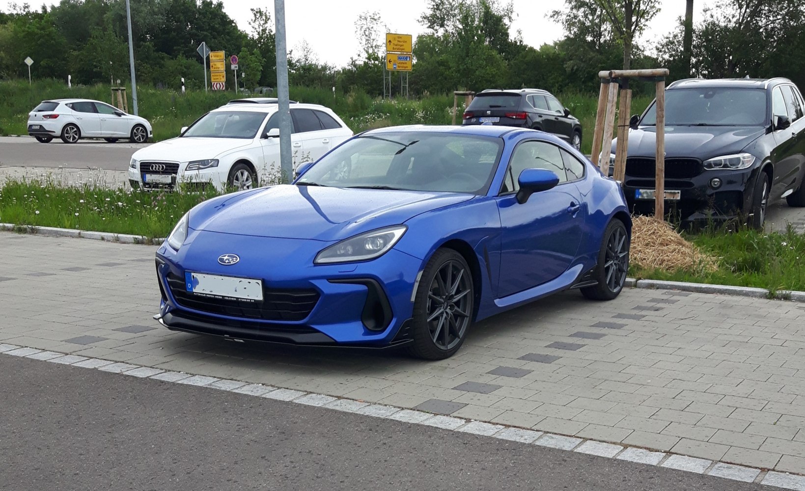 Blue sports coupe with aggressive front end and sleek design