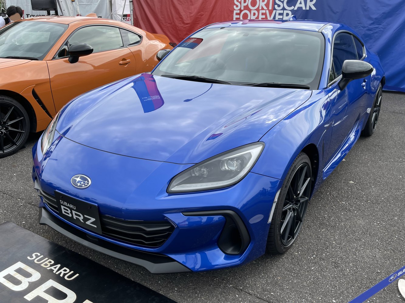 Blue sports coupe with sharp headlights and aerodynamic front design