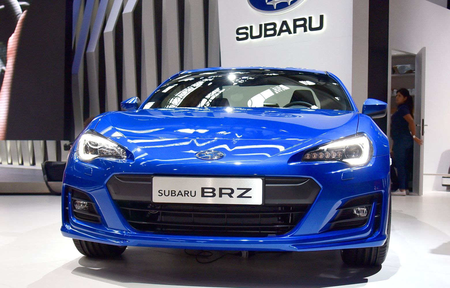 Front view of blue sports coupe with LED headlights and grille