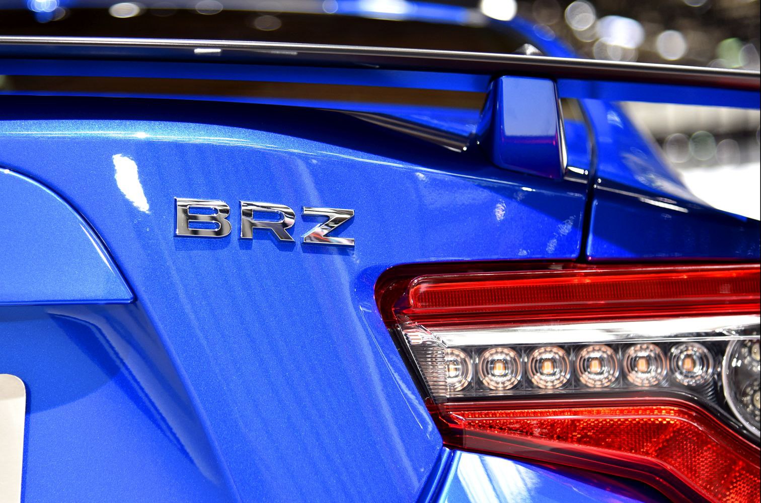 Rear badge and LED taillight close-up of a sports coupe.