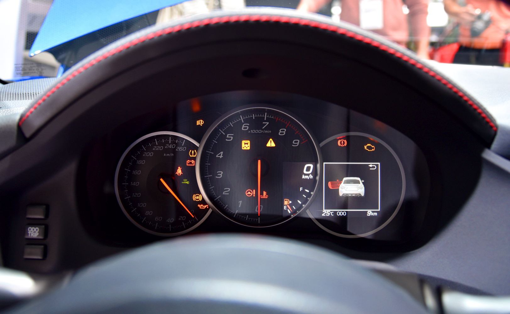 Instrument cluster with tachometer, speedometer, and digital display with warning lights