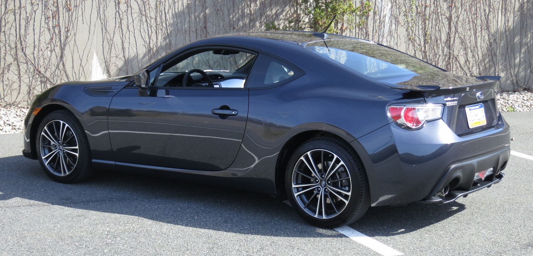 Side profile of a sporty coupe with alloy wheels and aerodynamic design.