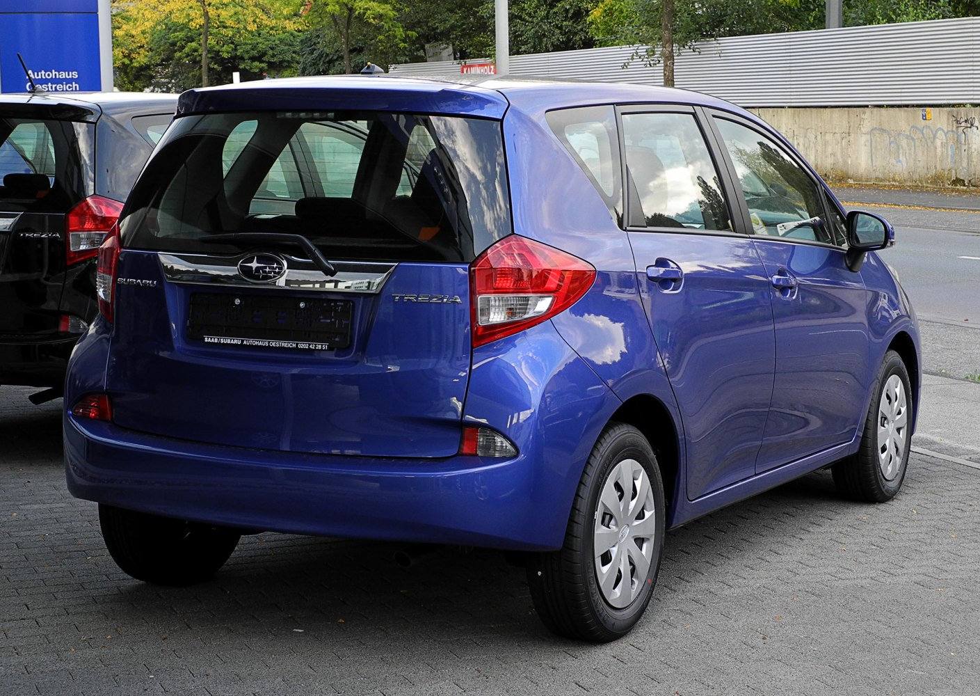 Rear view with distinctive tail lights and rear hatch of a compact hatchback.