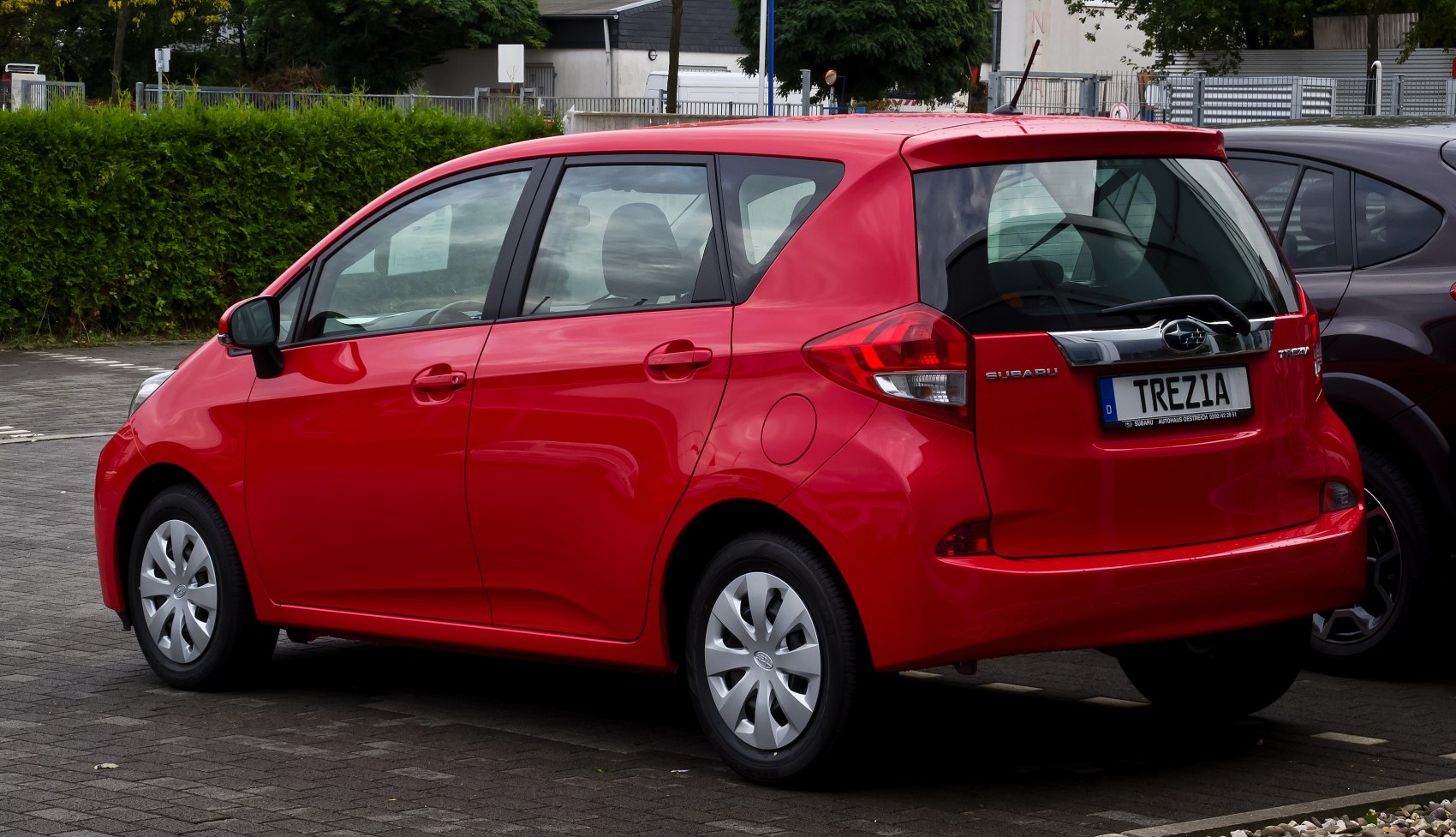 Compact hatchback rear profile with angular tail lights and rear wiper