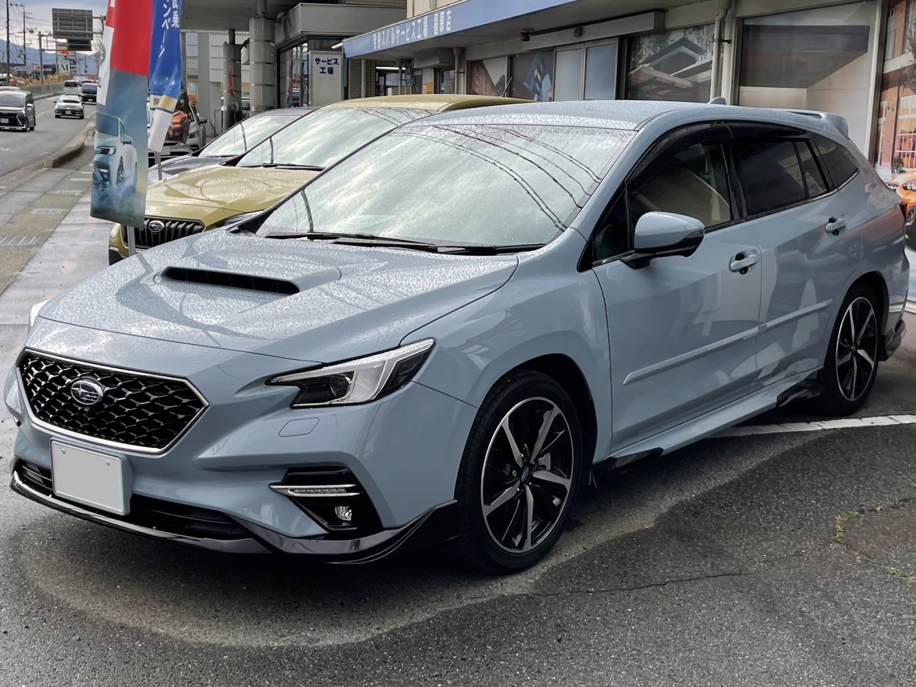 Hatchback front-side view with hood scoop and sleek LED headlights