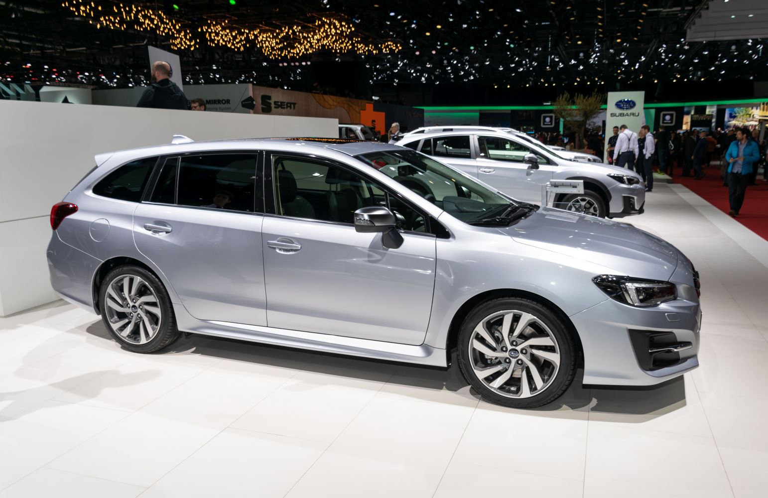 Silver station wagon with alloy wheels in side profile.