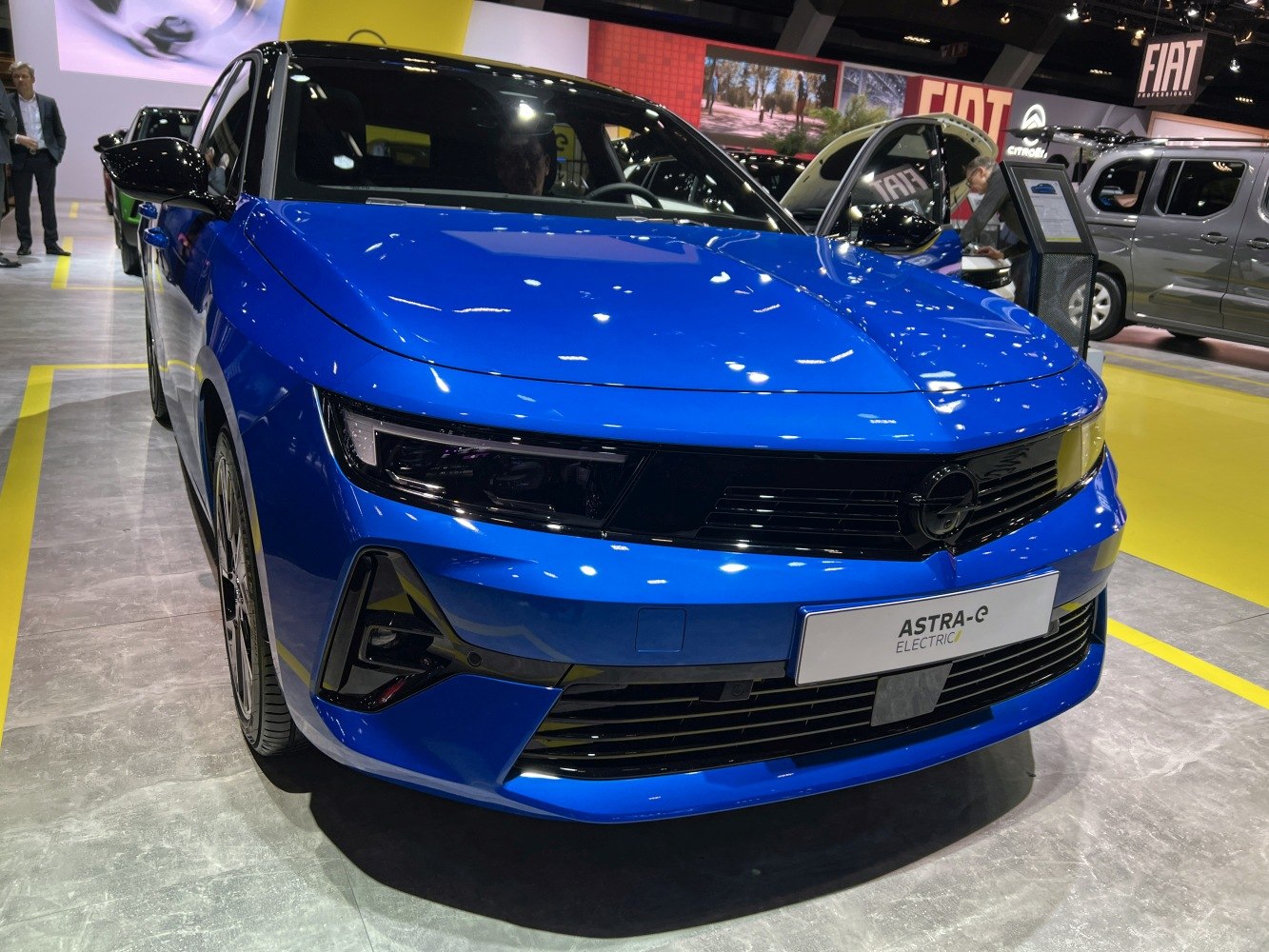 Front view of a blue electric hatchback with sleek headlights and modern grille