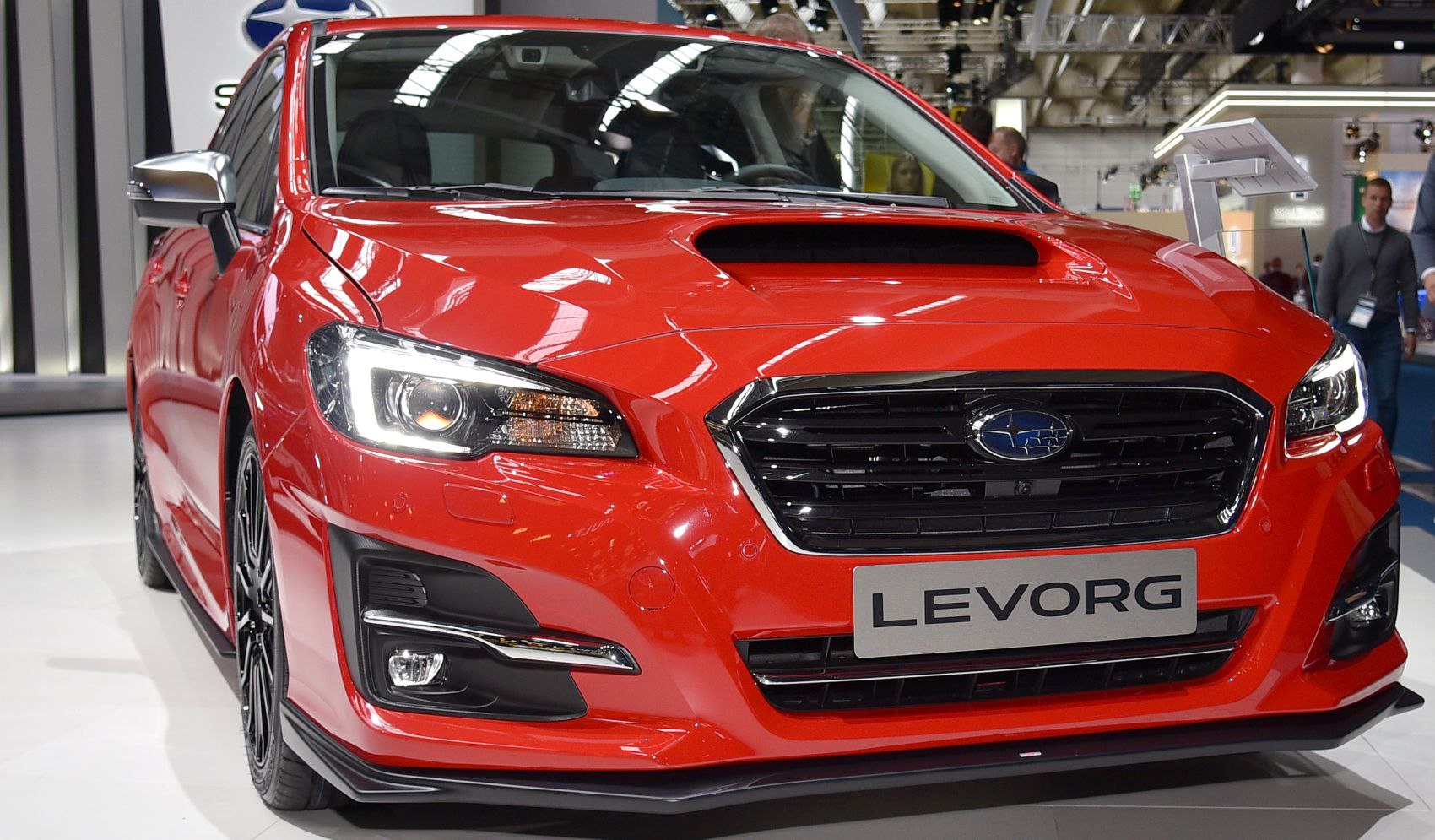 Close-up of front with illuminated LED headlights, hood scoop, aggressive grille