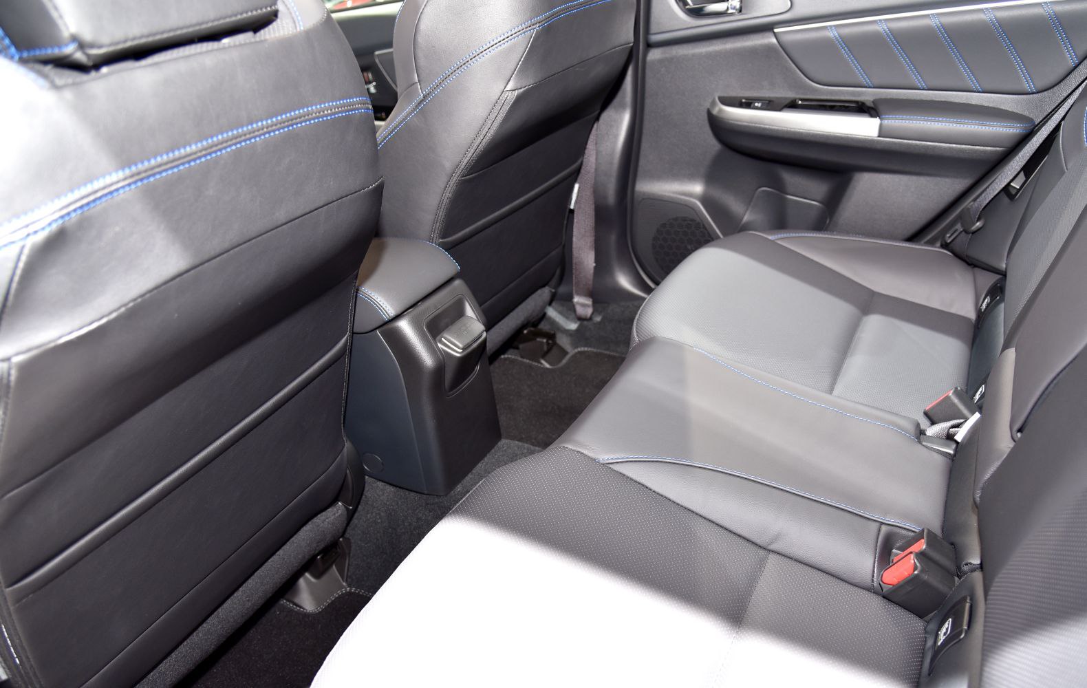 Rear seat interior with black leather and blue stitching