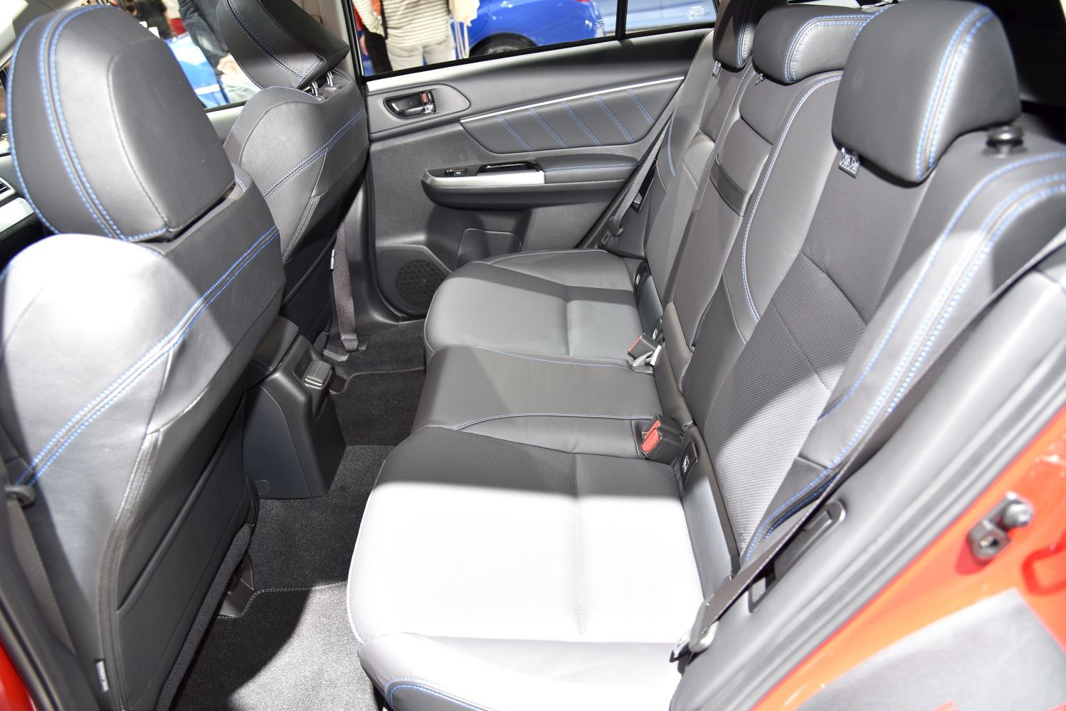 Spacious rear seat interior with black leather and blue stitching