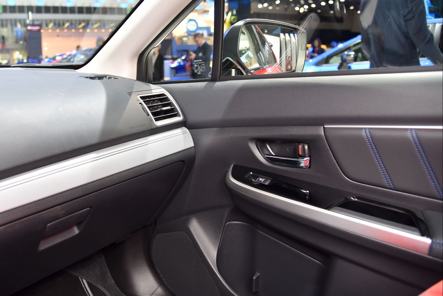 Car interior door panel with chrome handle and dashboard air vent