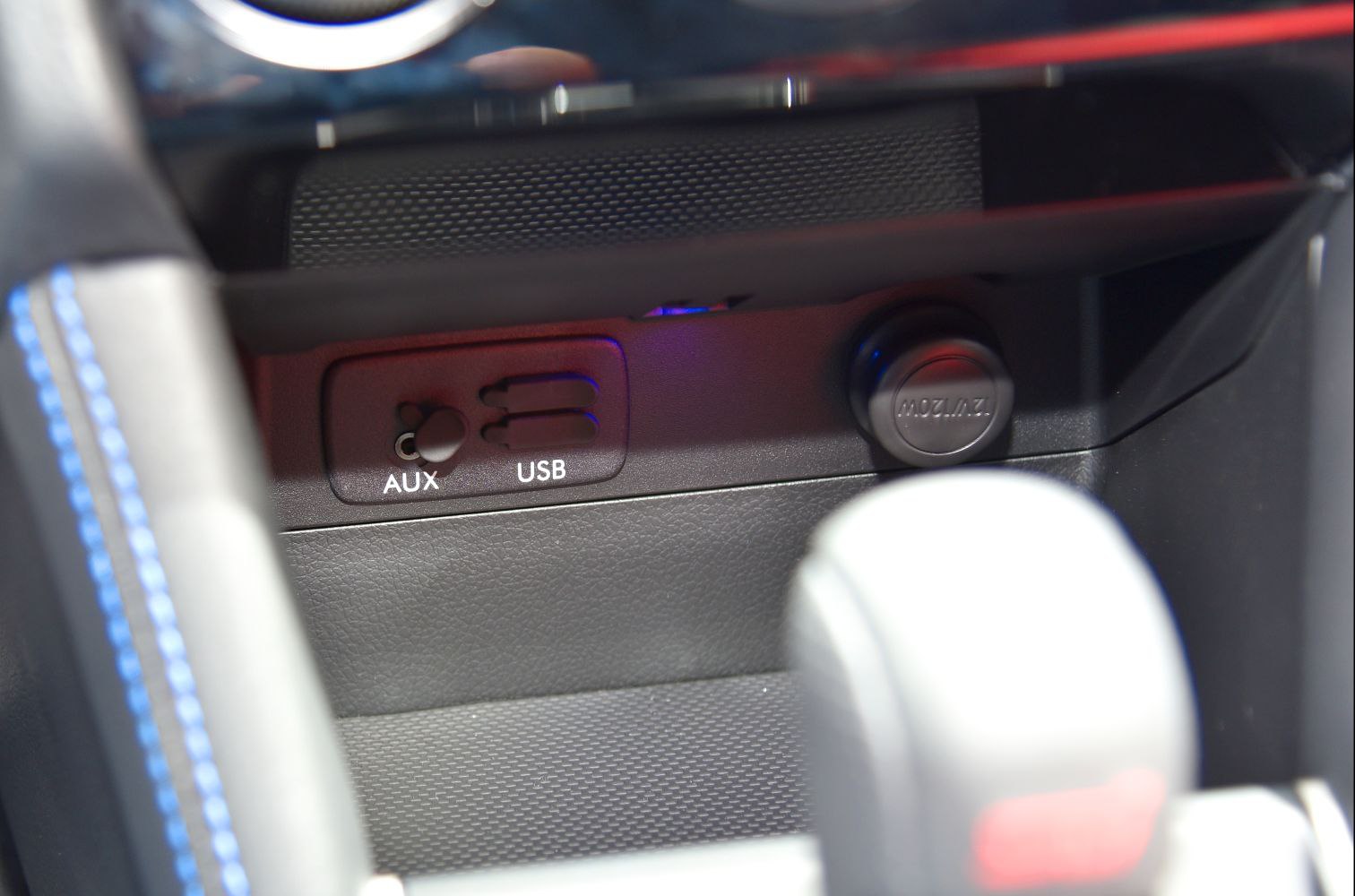 AUX and USB ports with power outlet in car interior console
