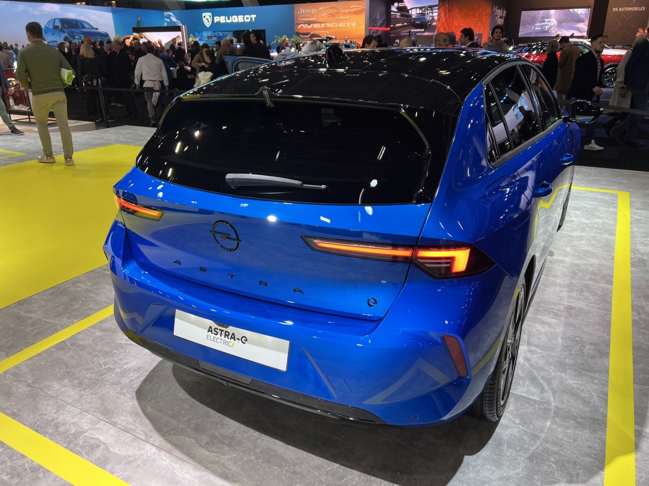 Rear view of modern electric hatchback with sleek tail lights and black roof