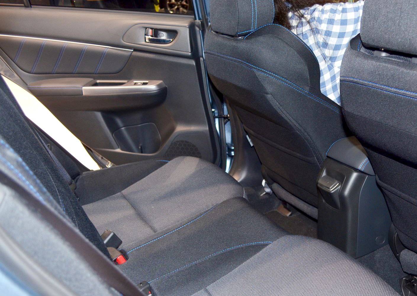 Black fabric rear seats with blue stitching and spacious door panel