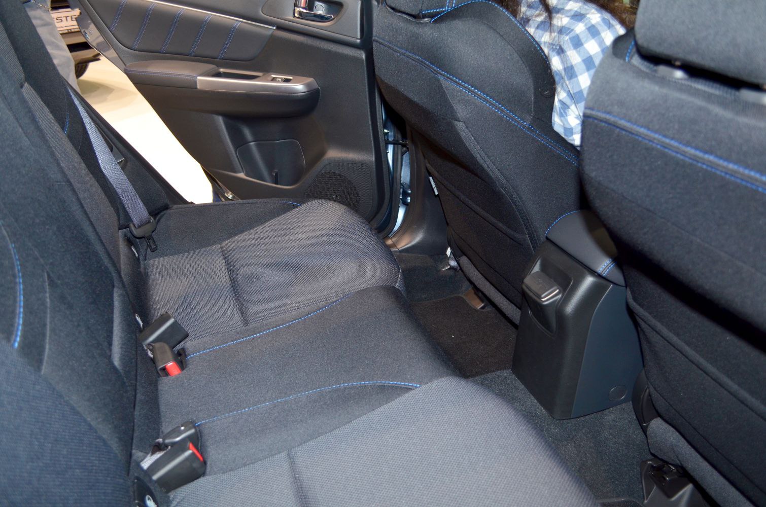 Black fabric rear seat with blue stitching and door panel features