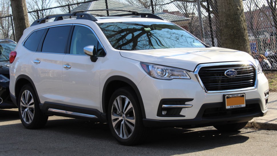 Modern SUV with prominent front grille and roof rails in white finish