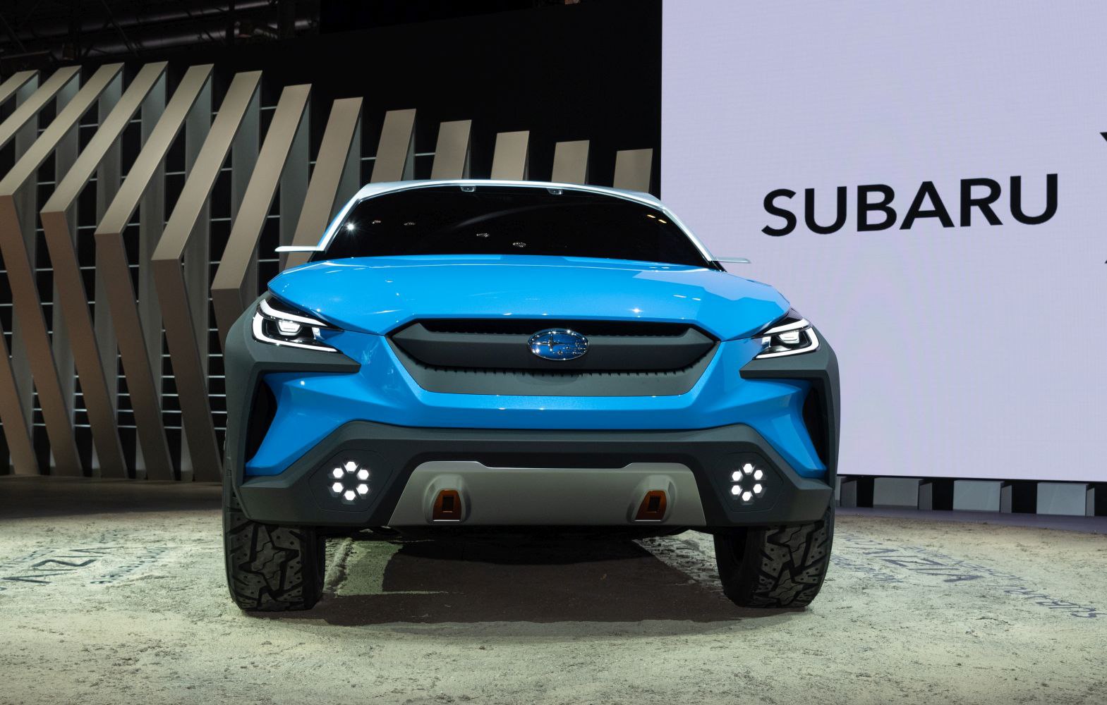 Futuristic front view featuring LED headlights and unique grille design