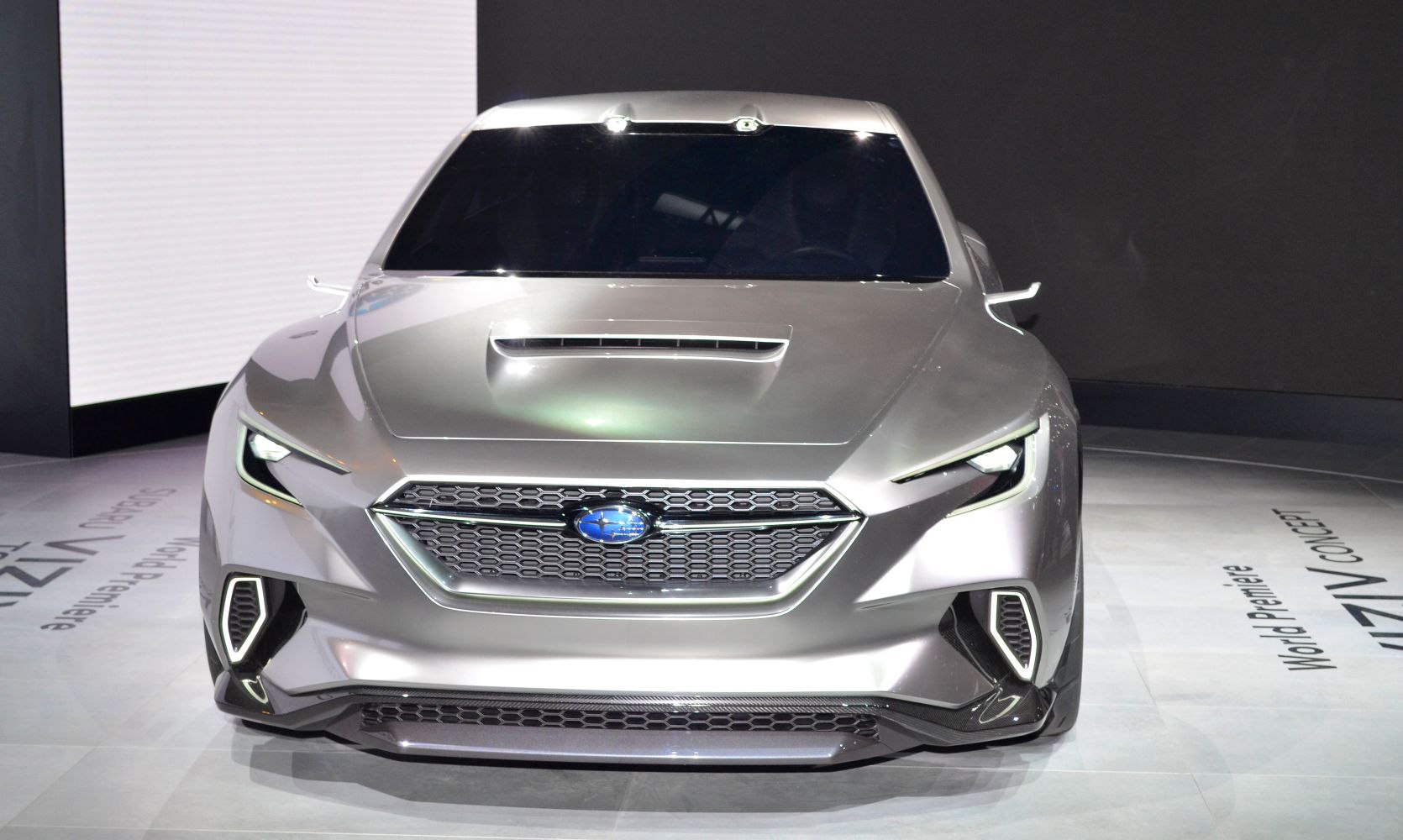 Front view with hexagonal grille, sharp LED lights, and hood scoop
