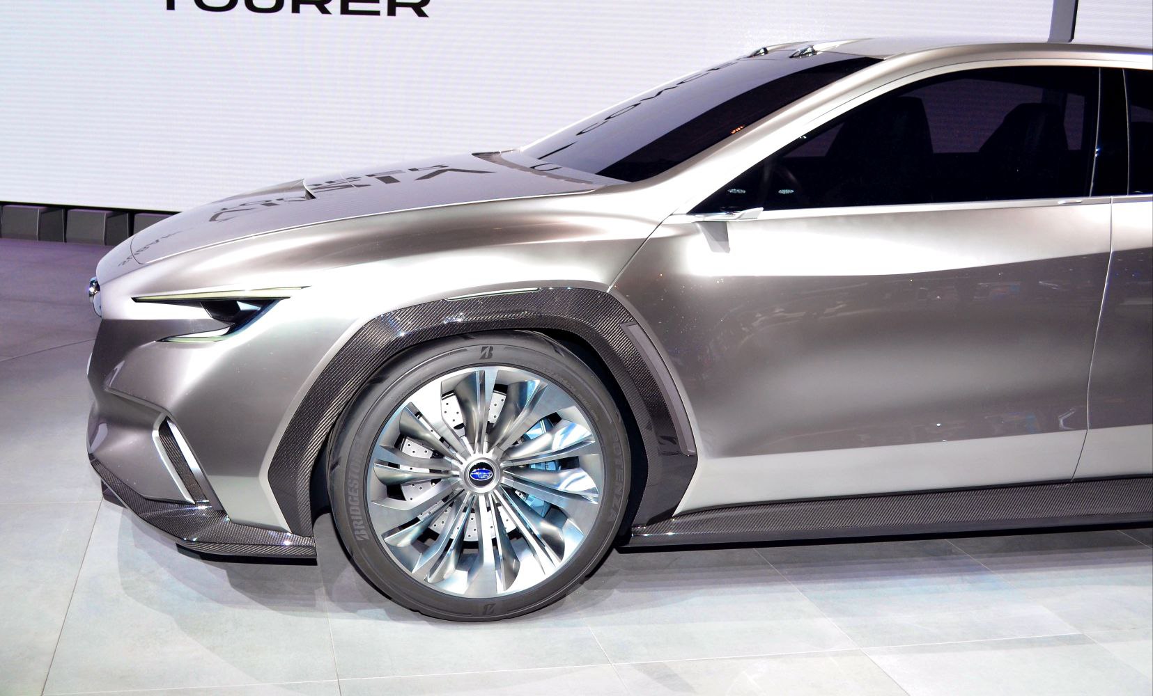 Front side profile and futuristic wheel with carbon fiber accents