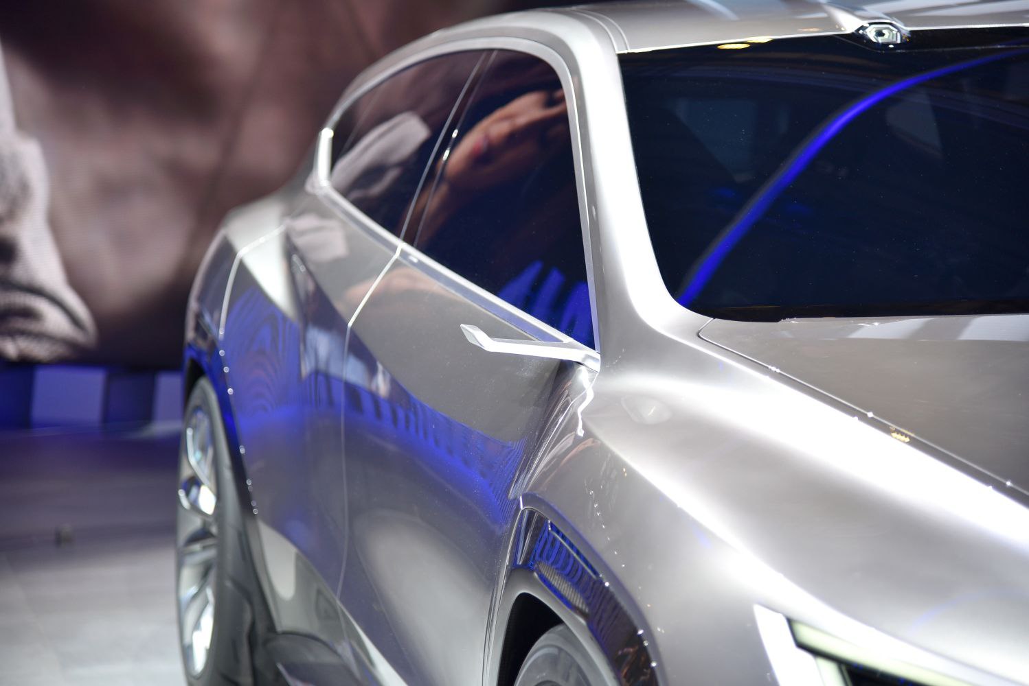 Silver side profile with futuristic side mirror and tinted windows