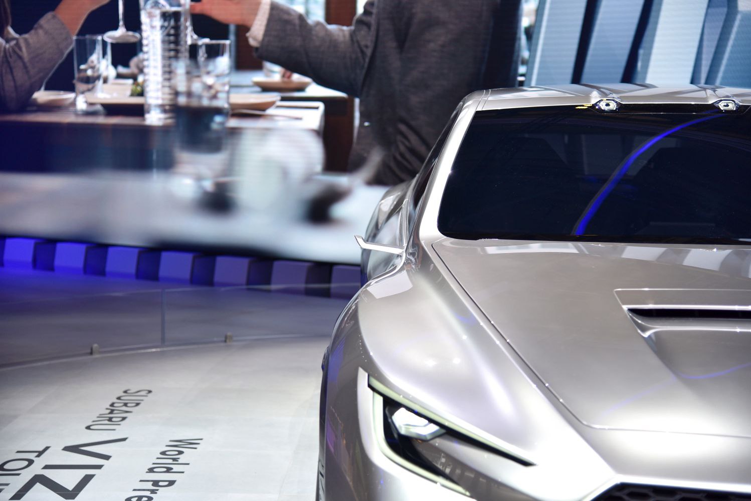 Sharp headlight and distinctive hood vent on a concept vehicle.