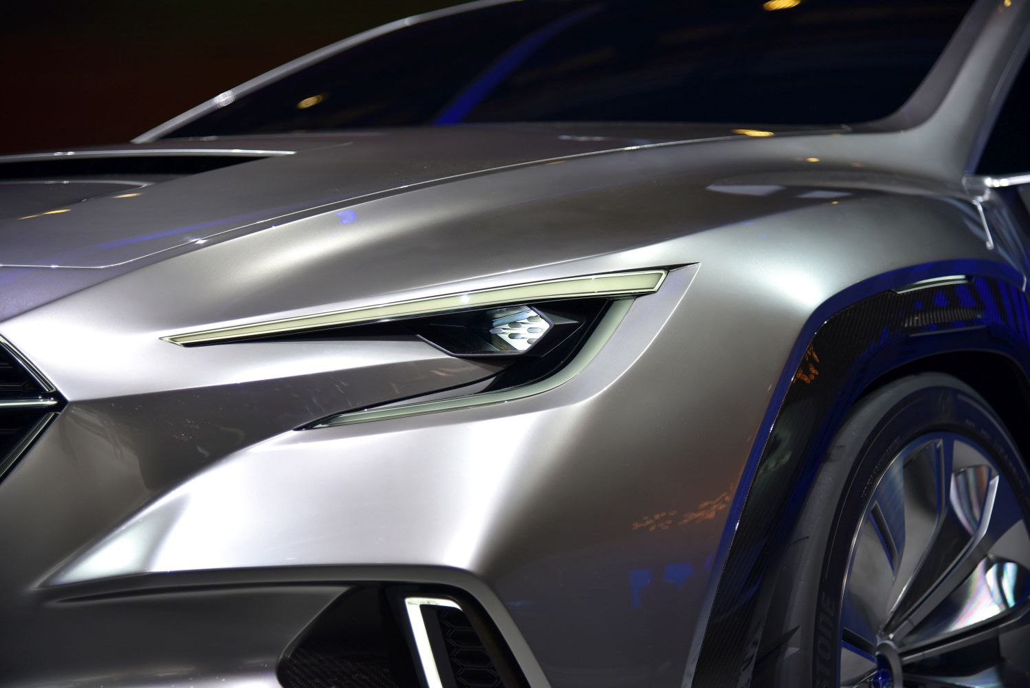 Futuristic sleek headlight and front wheel of silver concept car