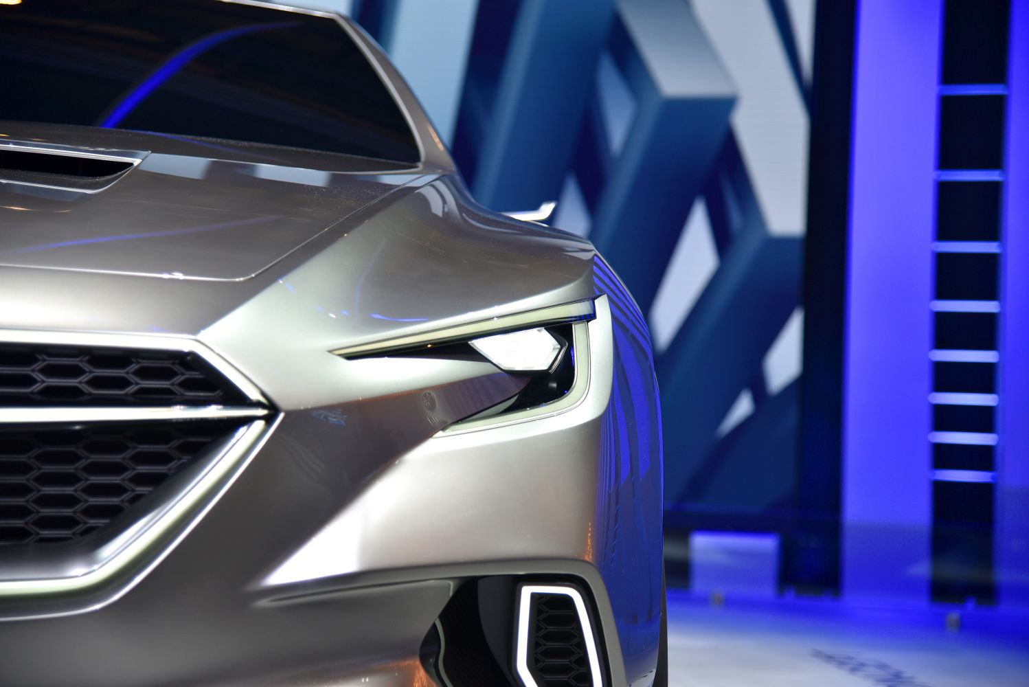 Close-up of aggressive front grille and sharp angular headlight