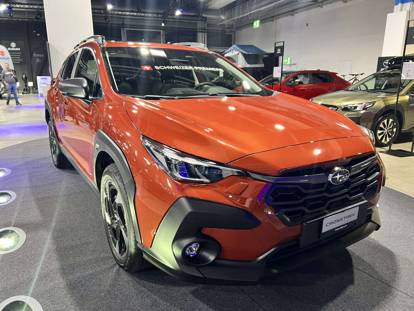 Front grille and LED headlights of modern orange SUV.