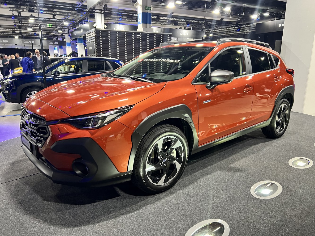 Orange SUV with modern headlights and distinctive grille design