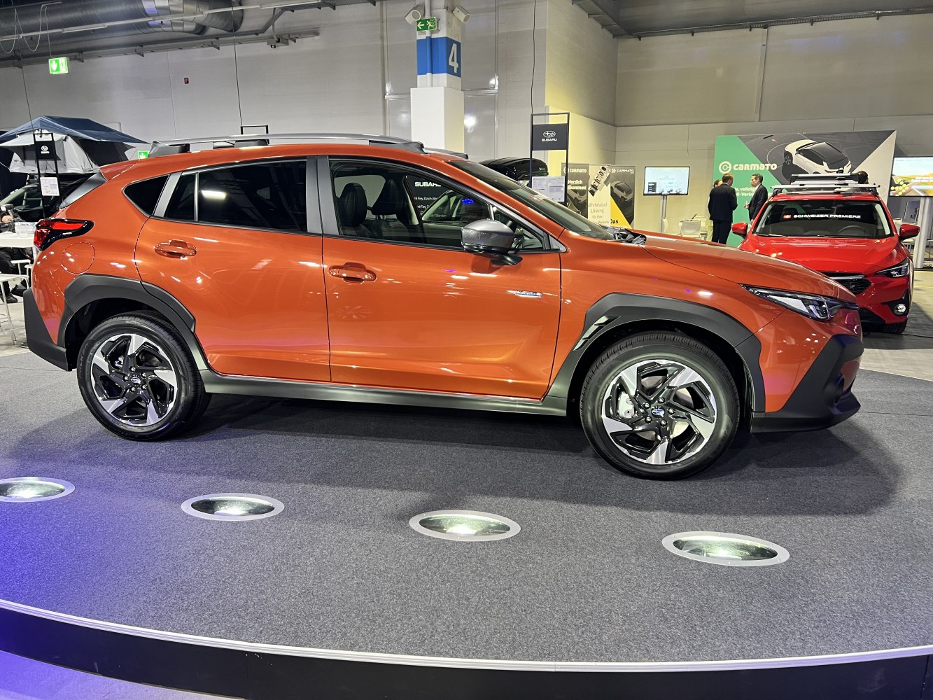 Side profile and alloy wheels of a modern compact SUV on display platform