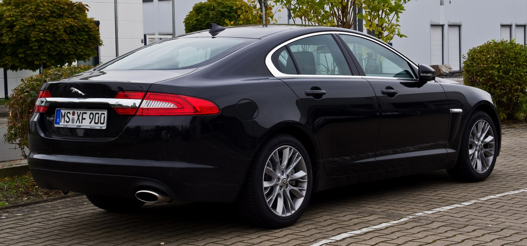Rear and side profile of a luxury sedan with distinctive taillights and alloy wheels