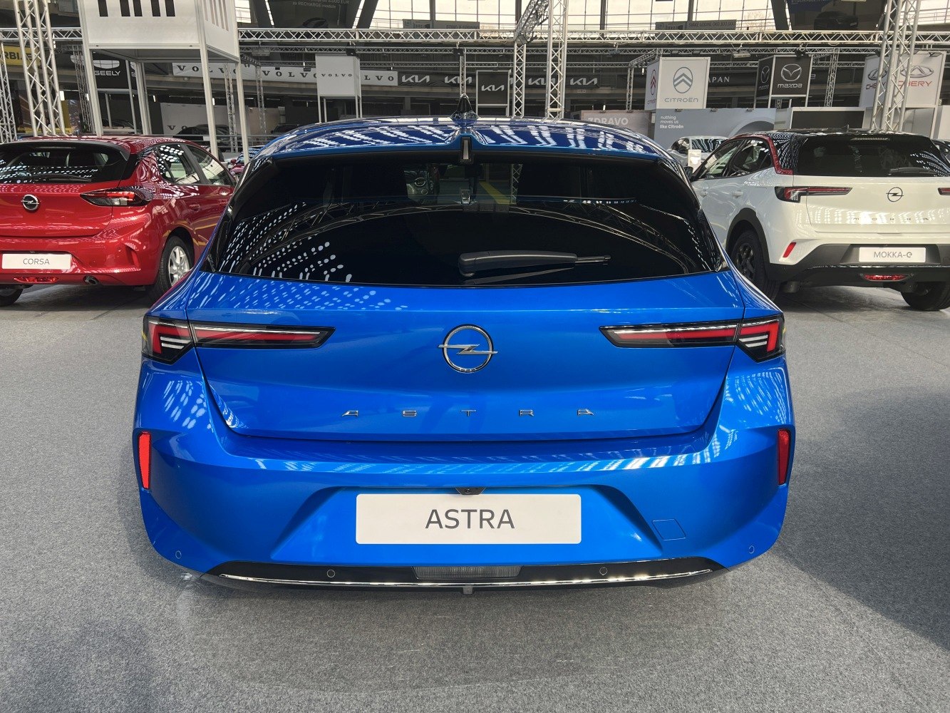 Rear view of a blue hatchback with sleek LED taillights and clean design
