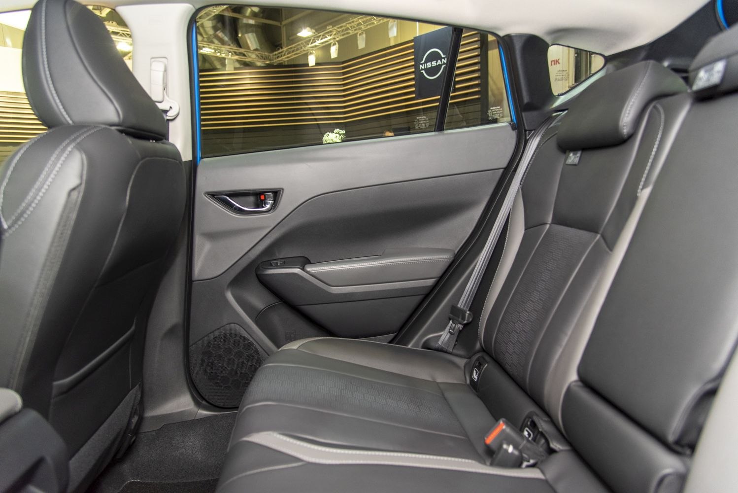 Rear seat interior with black leather upholstery and modern door panel