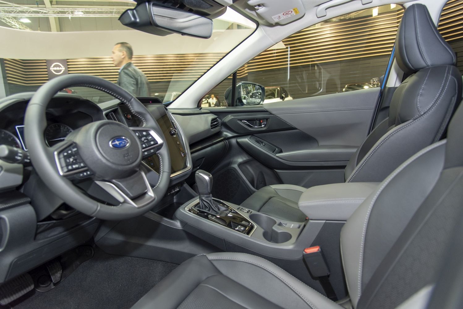 Modern car interior with dashboard, steering wheel, and front seats