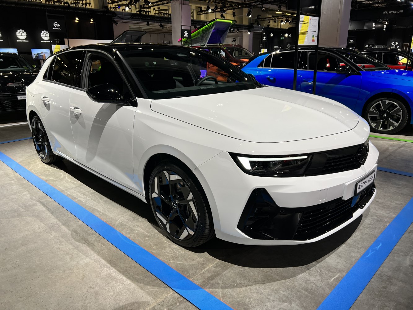 White hatchback with black roof and sporty wheels