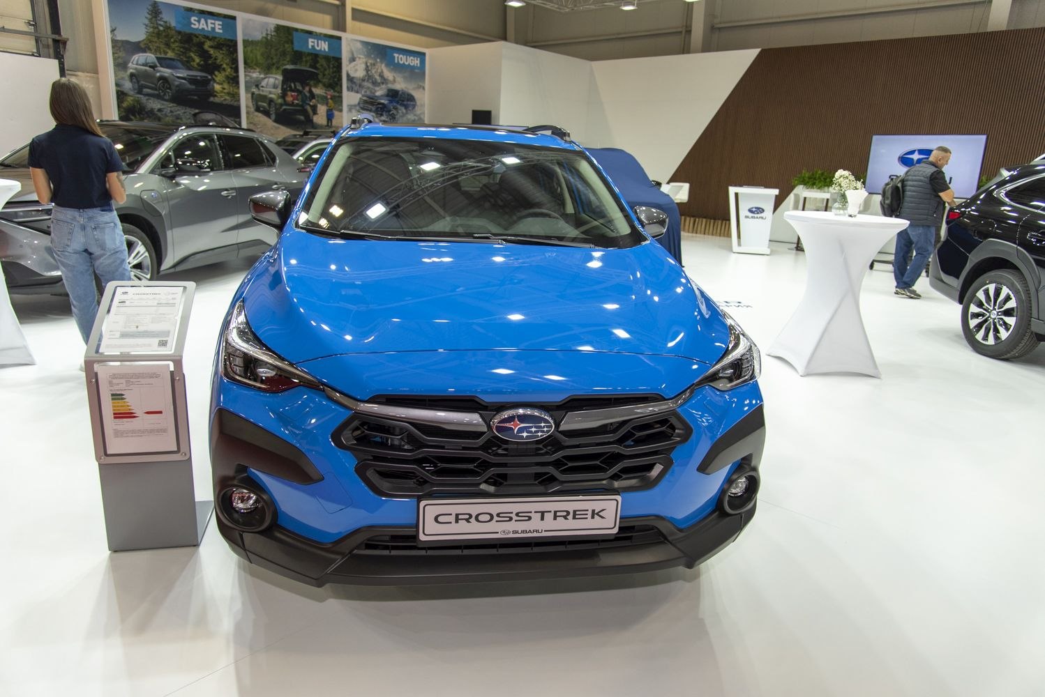 Front view of a bold grille and sleek headlights in vibrant blue.