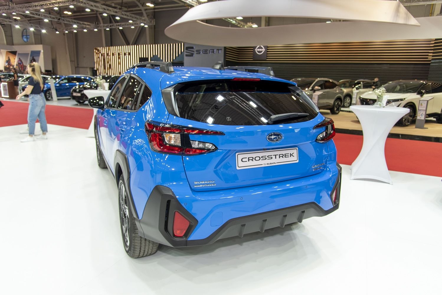Rear view of a blue compact SUV featuring distinct taillights and roof rails