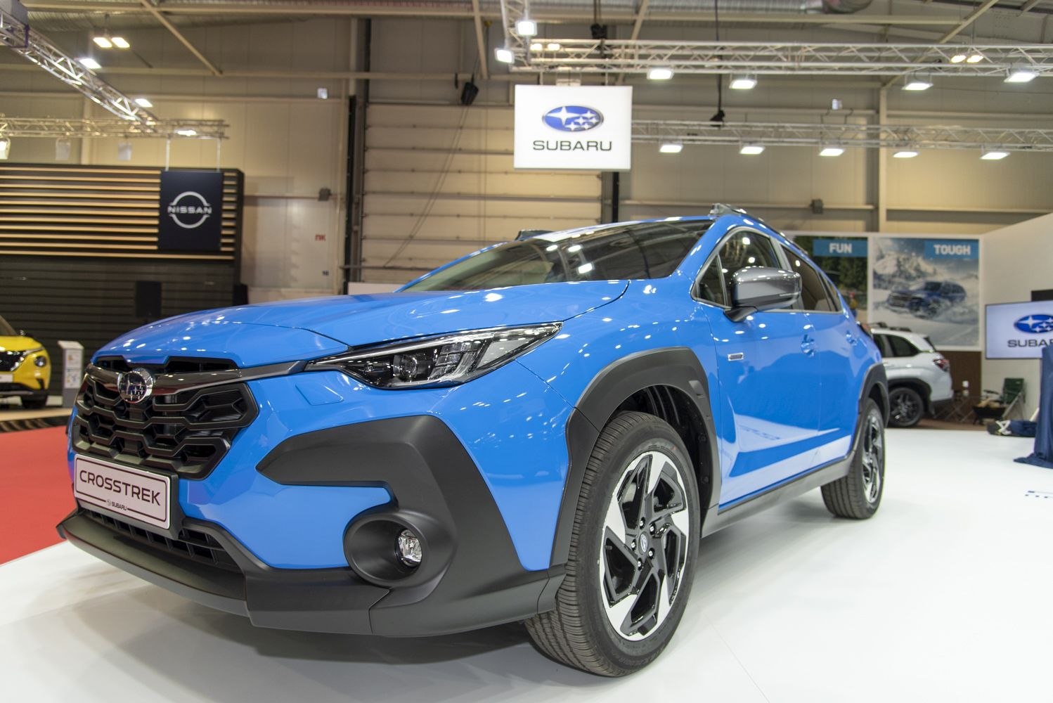 Front view featuring LED headlights and alloy wheels in a blue vehicle