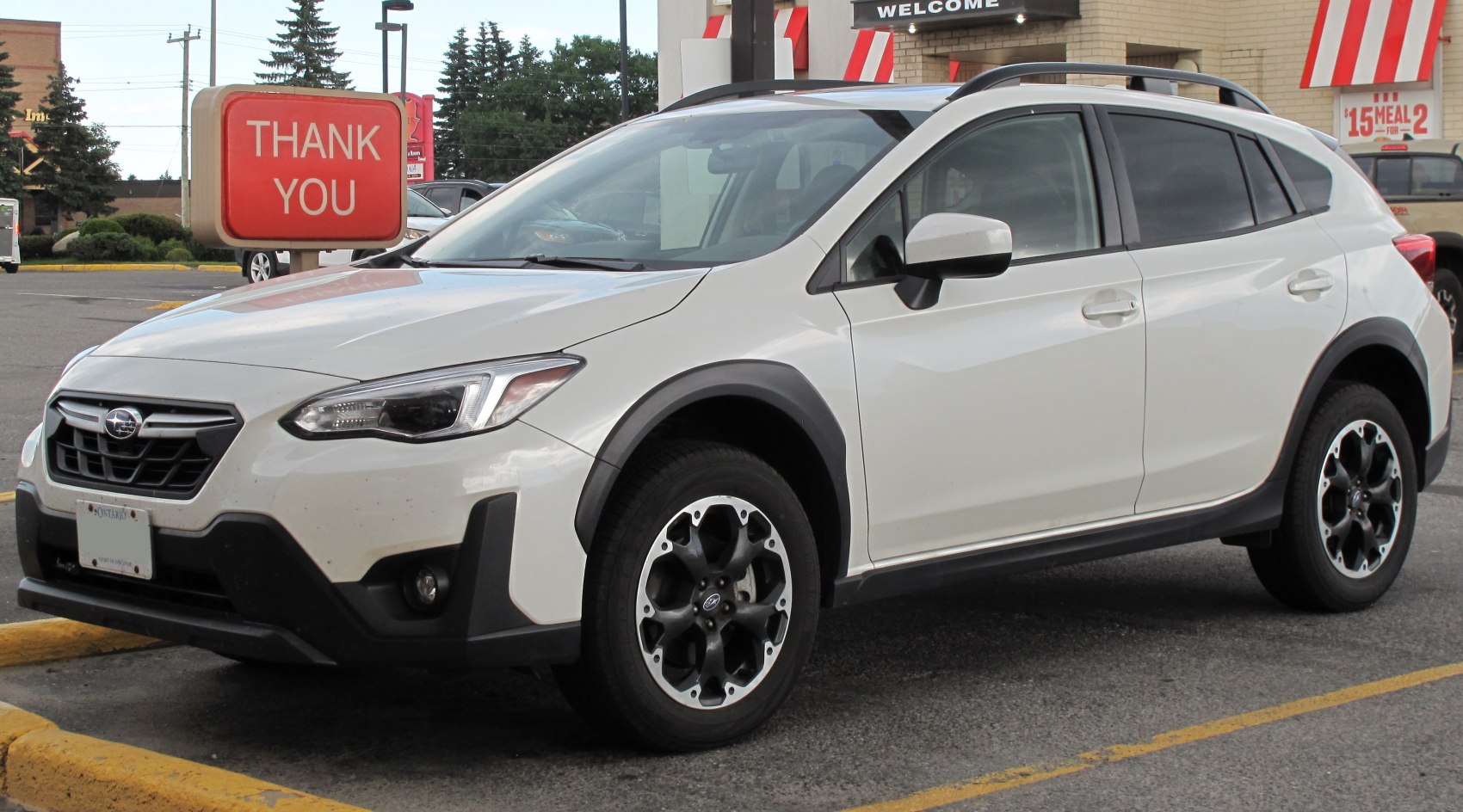 White compact SUV with black trim and alloy wheels front side view
