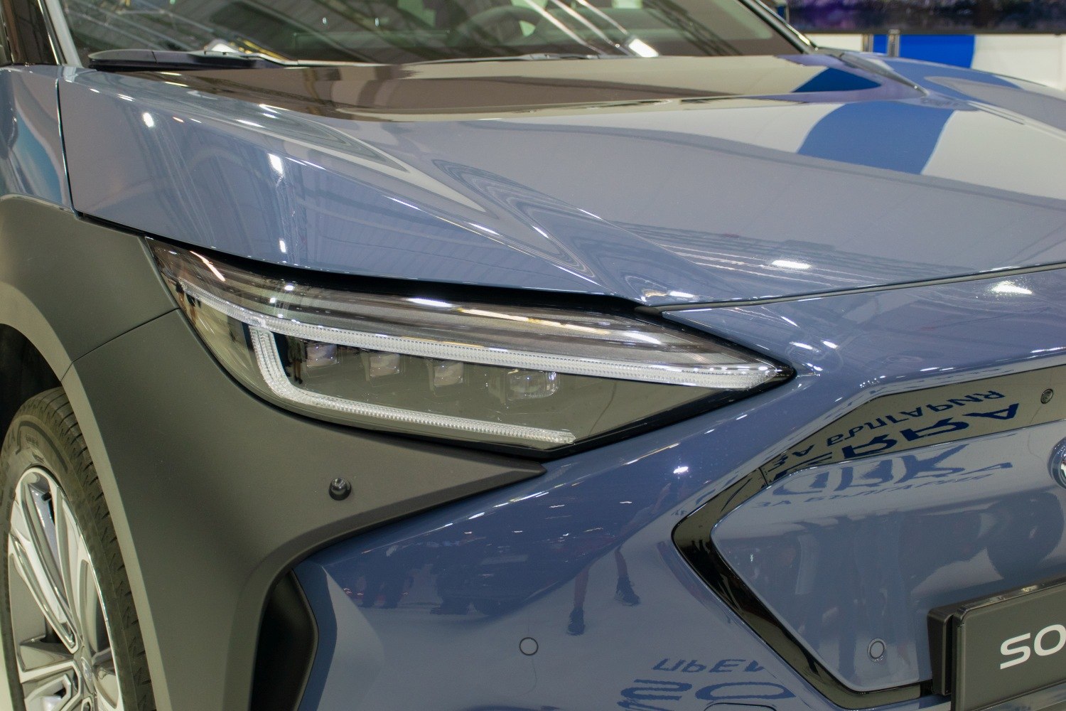 Close-up of front headlight and hood with LED lamp design.