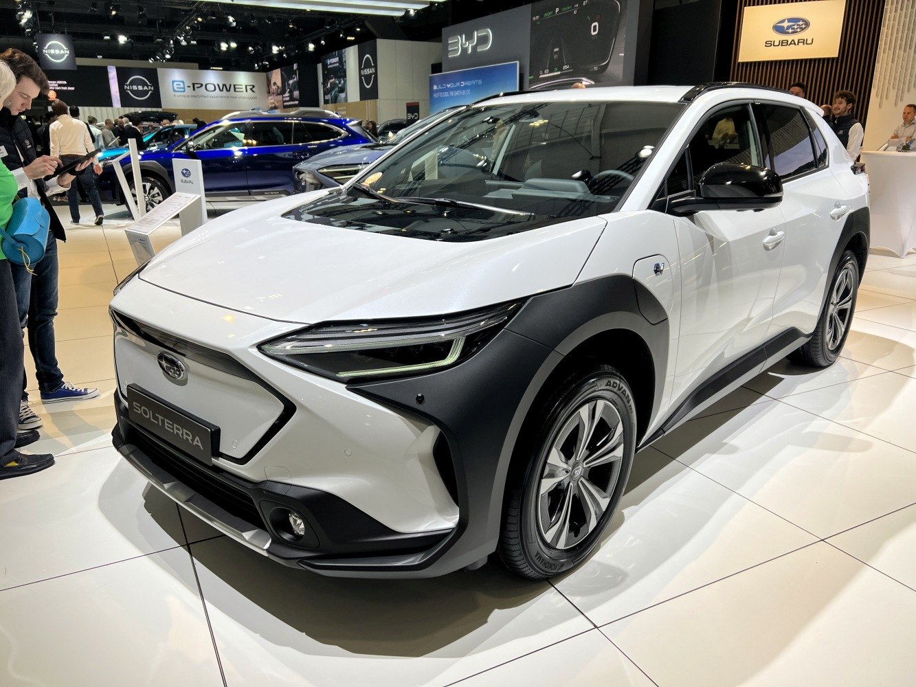 Front three-quarter view of modern electric SUV with sleek headlights and black trim
